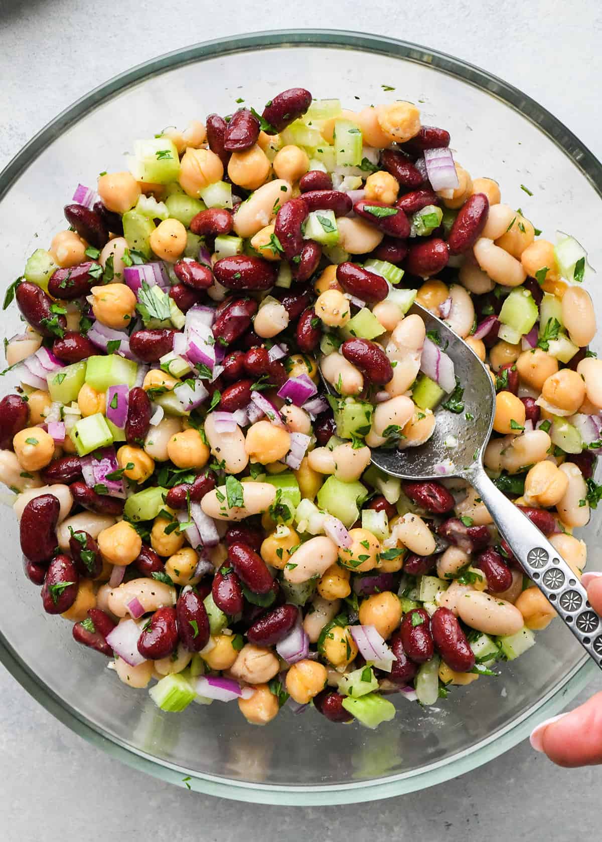 3 Bean Salad after being stirred in a bowl with a spoon