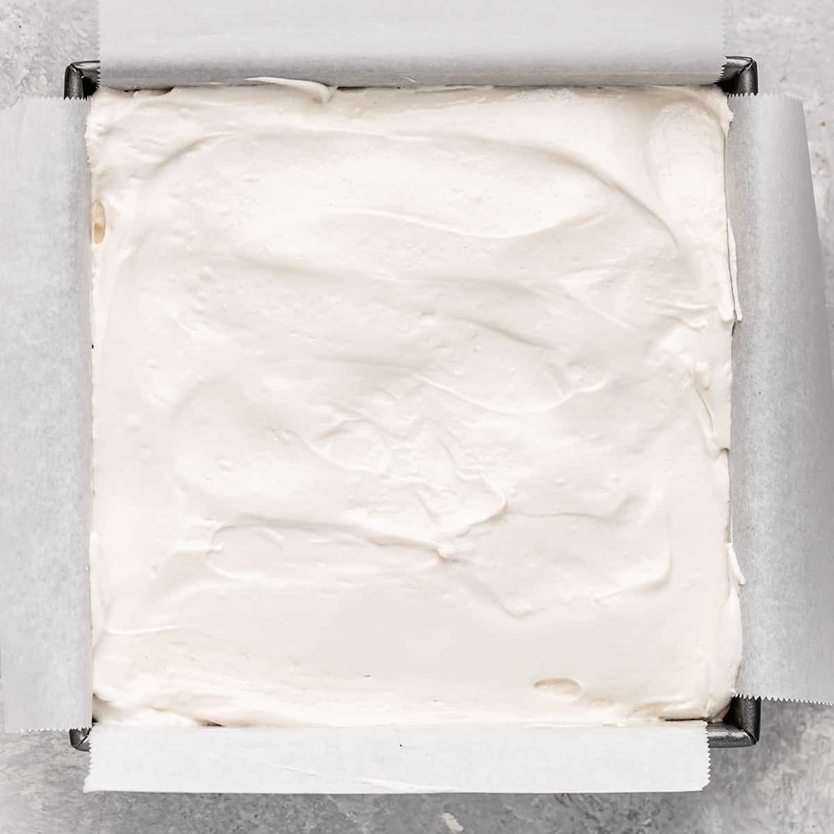 homemade marshmallow mixture spread into the bottom of the prepared pan