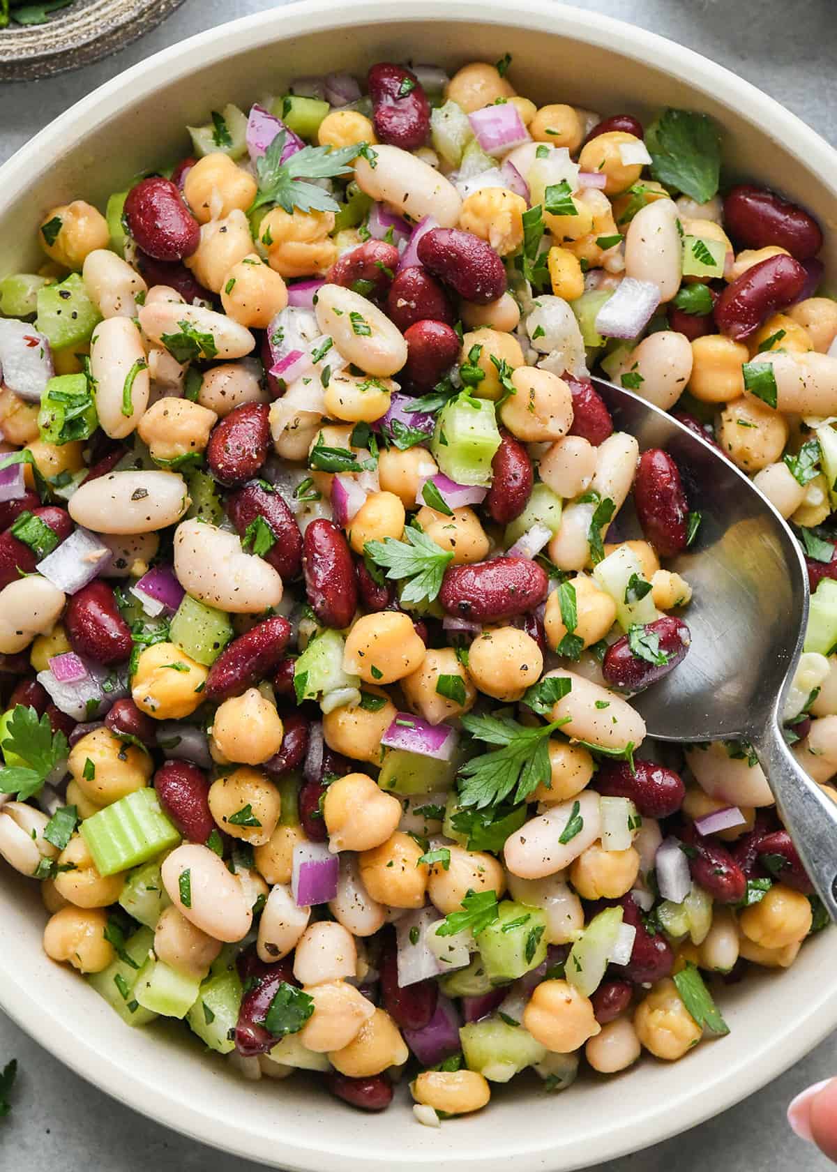 three bean salad in a bowl with a spoon