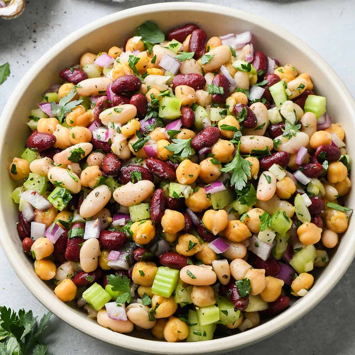 3 Bean Salad in a bowl garnished with parsley