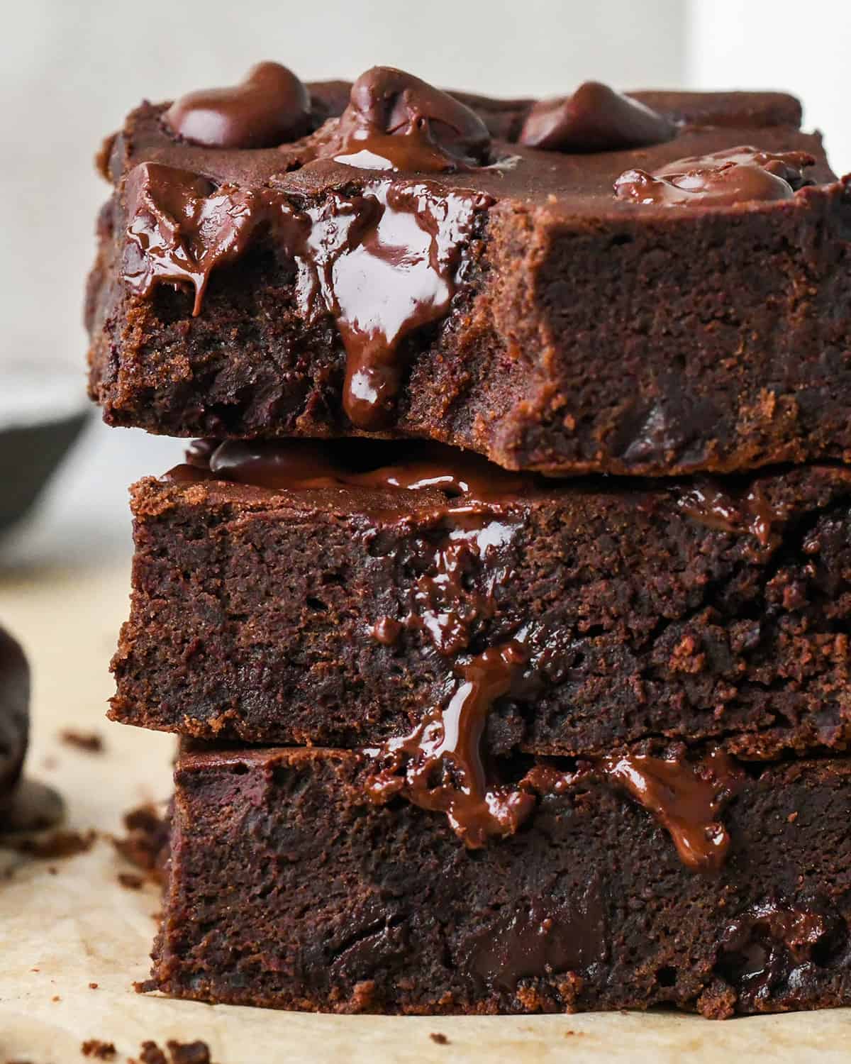 a stack of 3 Black Bean Brownies, the top one has a bite taken out of it