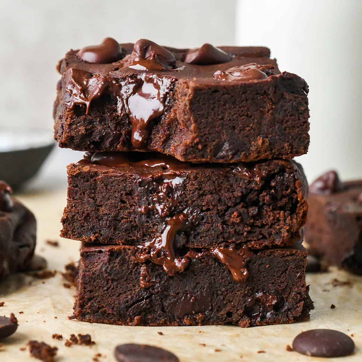 a stack of 3 Black Bean Brownies , top one has a bite taken out of it