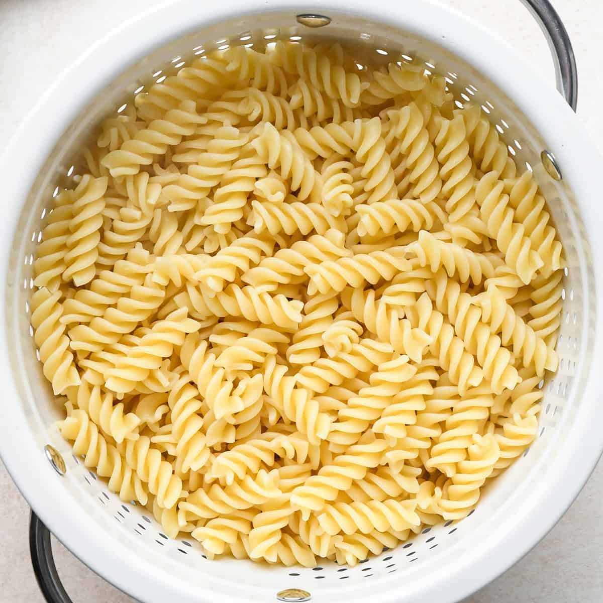 cooked fusili pasta in a colander