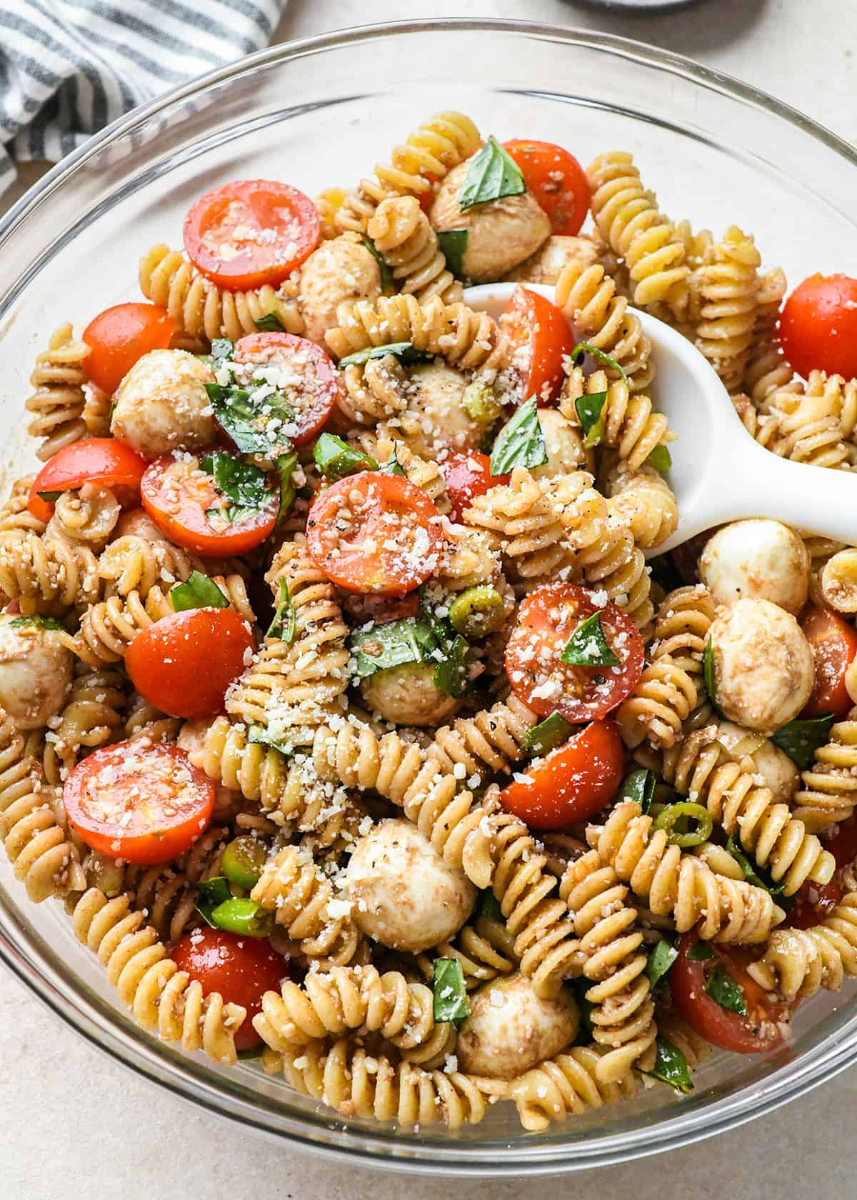 Caprese Pasta Salad after being stirred with a spoon