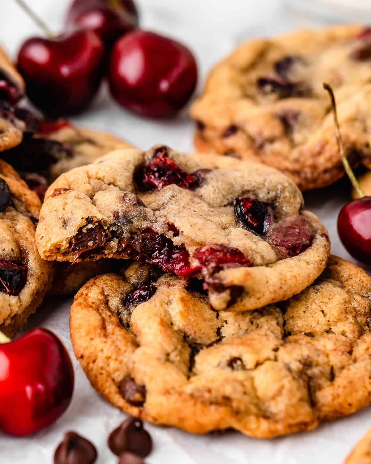 Cherry Cookies, one with a bite taken out of it to show the cherry and chocolate chips inside