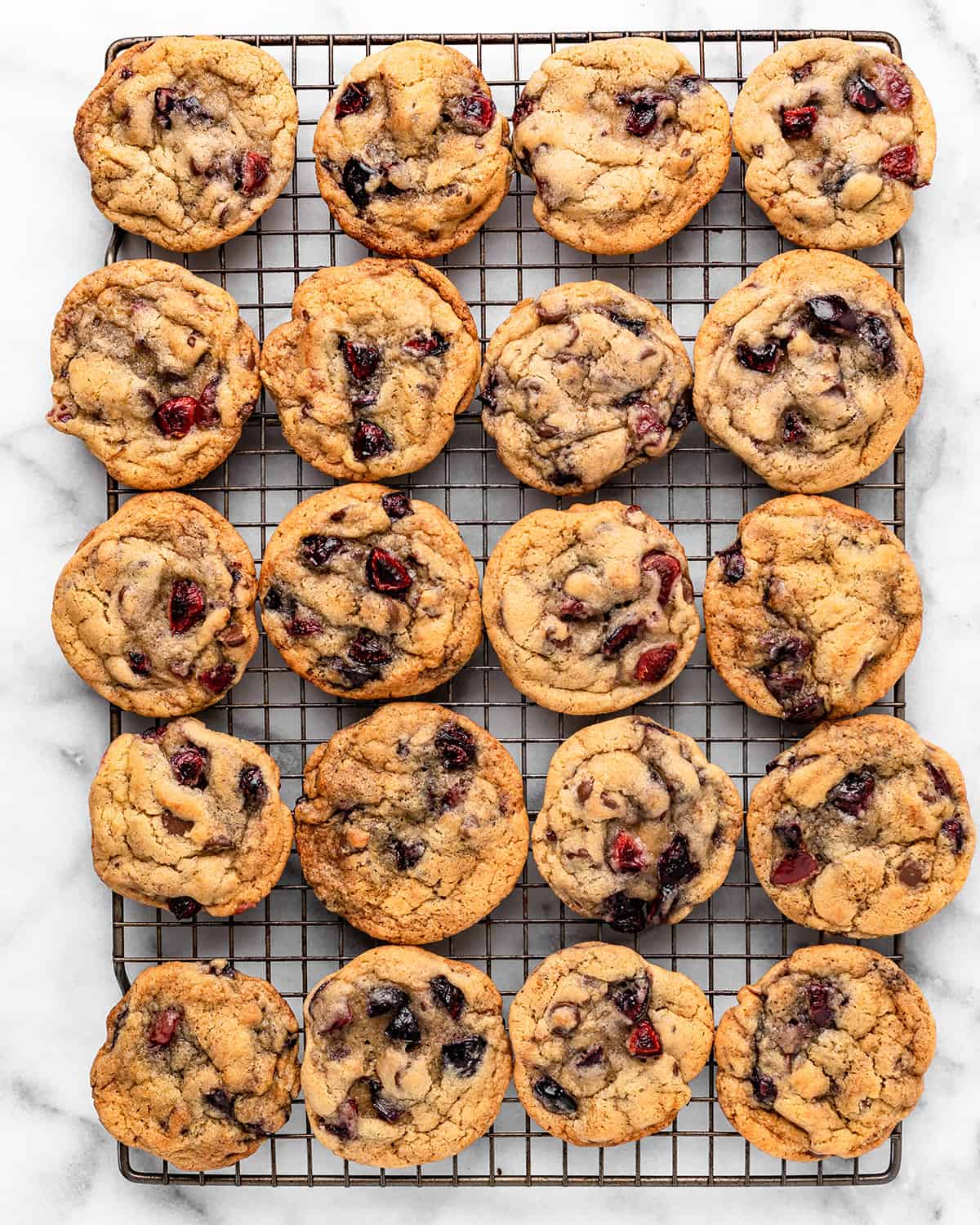 20 cherry cookies on a wire cooling rack