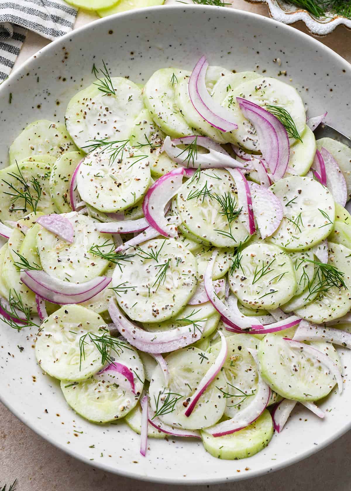 Cucumber Salad in a bowl garnished with fresh dill