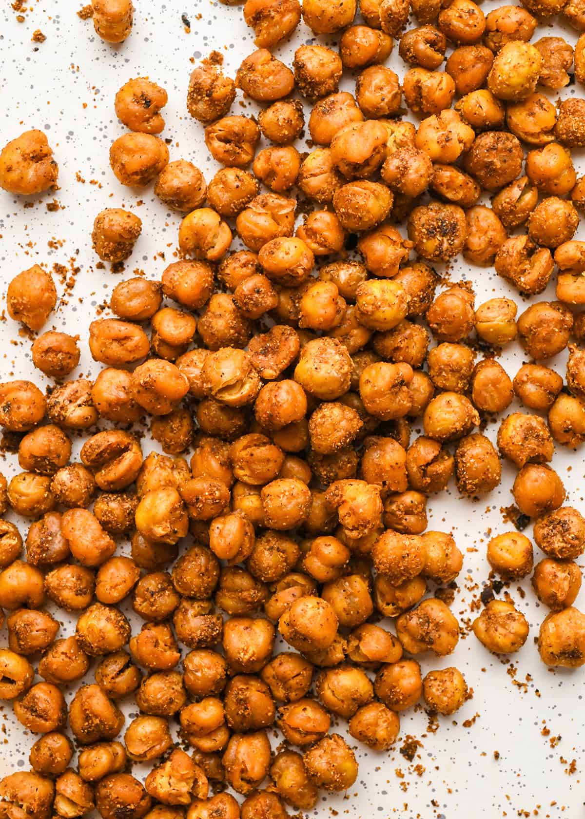 up close macro shot of Crispy Roasted Chickpeas so the crispy texture and spices on them are very visible and mouthwatering-looking!