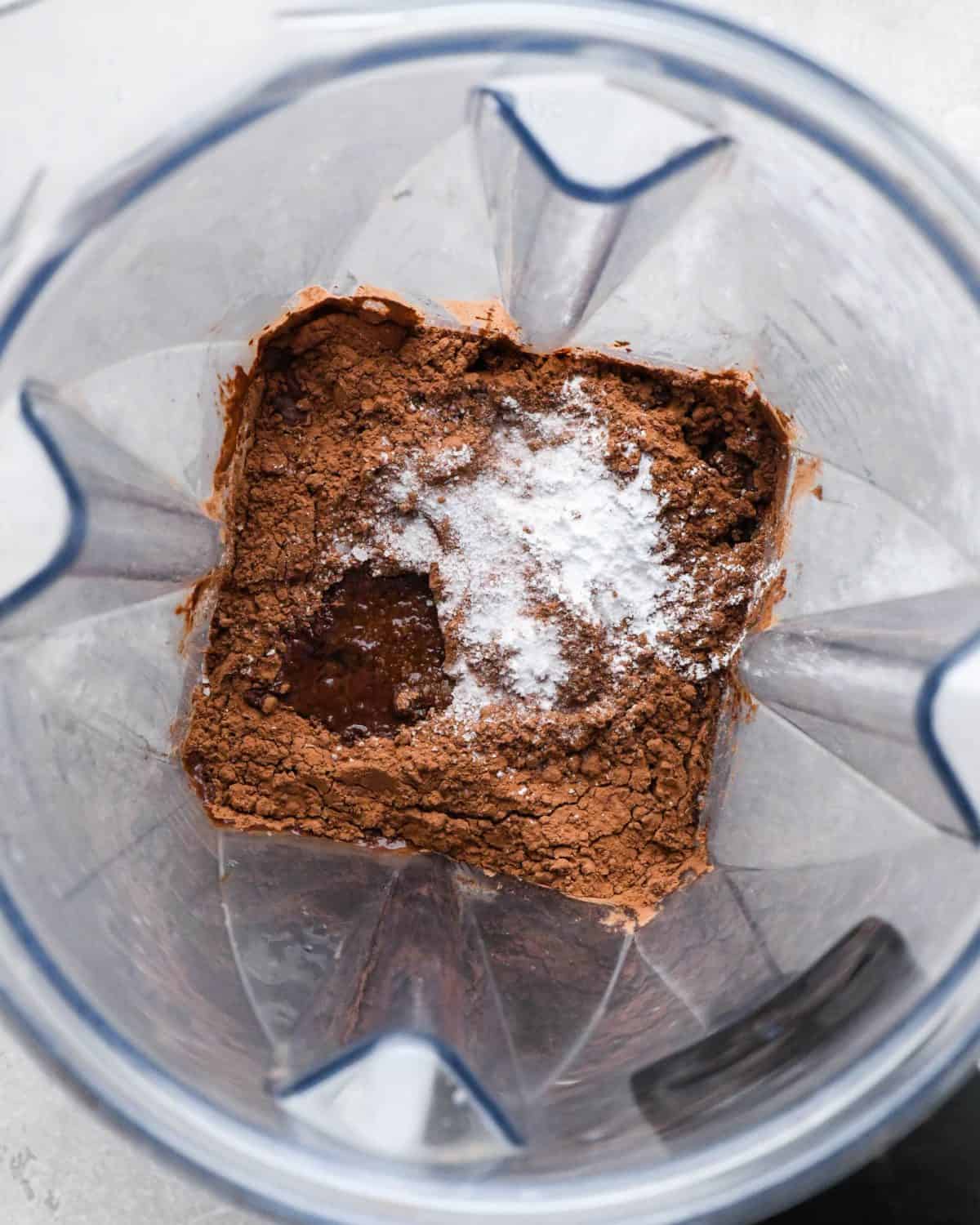 making black bean brownies - cocoa powder, vanilla, salt and baking powder added to the blending container before blending