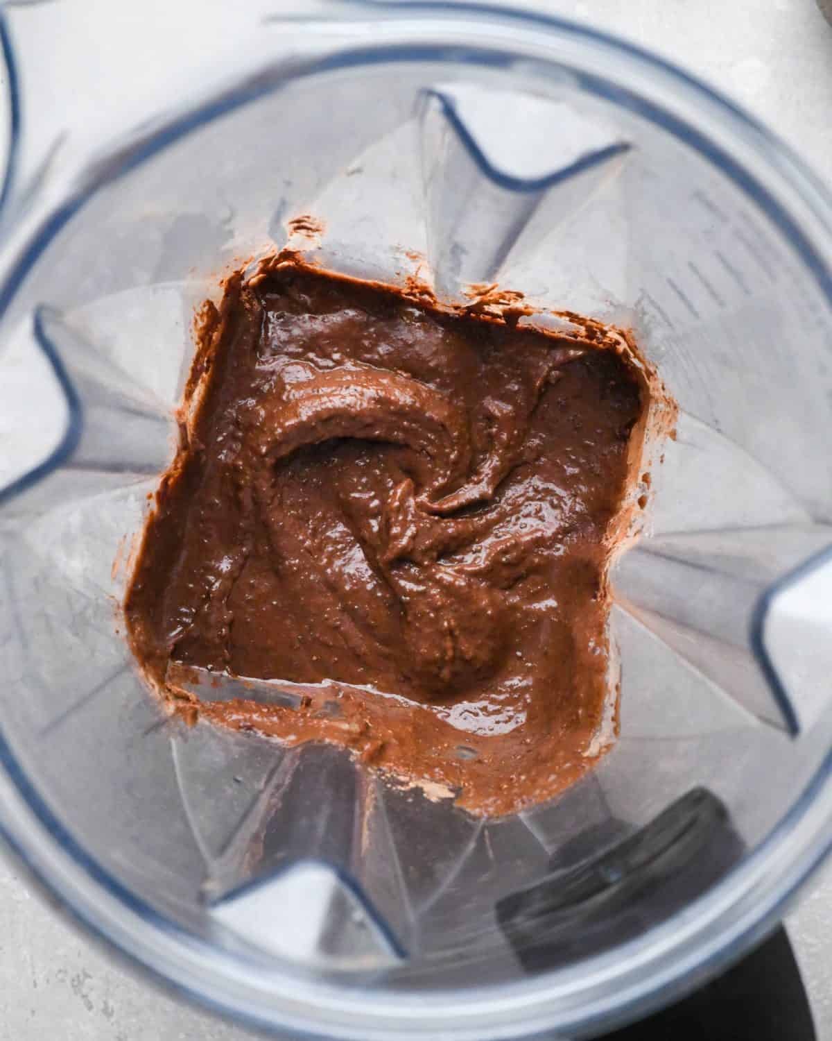 making black bean brownies - cocoa powder, vanilla, salt and baking powder added to the blending container after blending