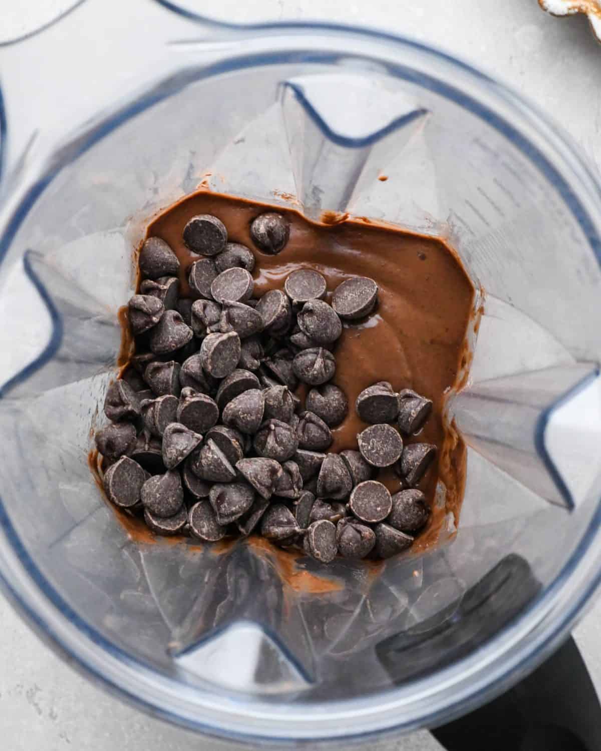 making black bean brownies - chocolate chips added to the batter in a blending contianer before stirring