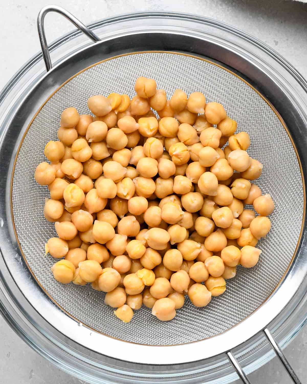 How to Roast Chickpeas  - draining chickpeas in a metal sieve. 
