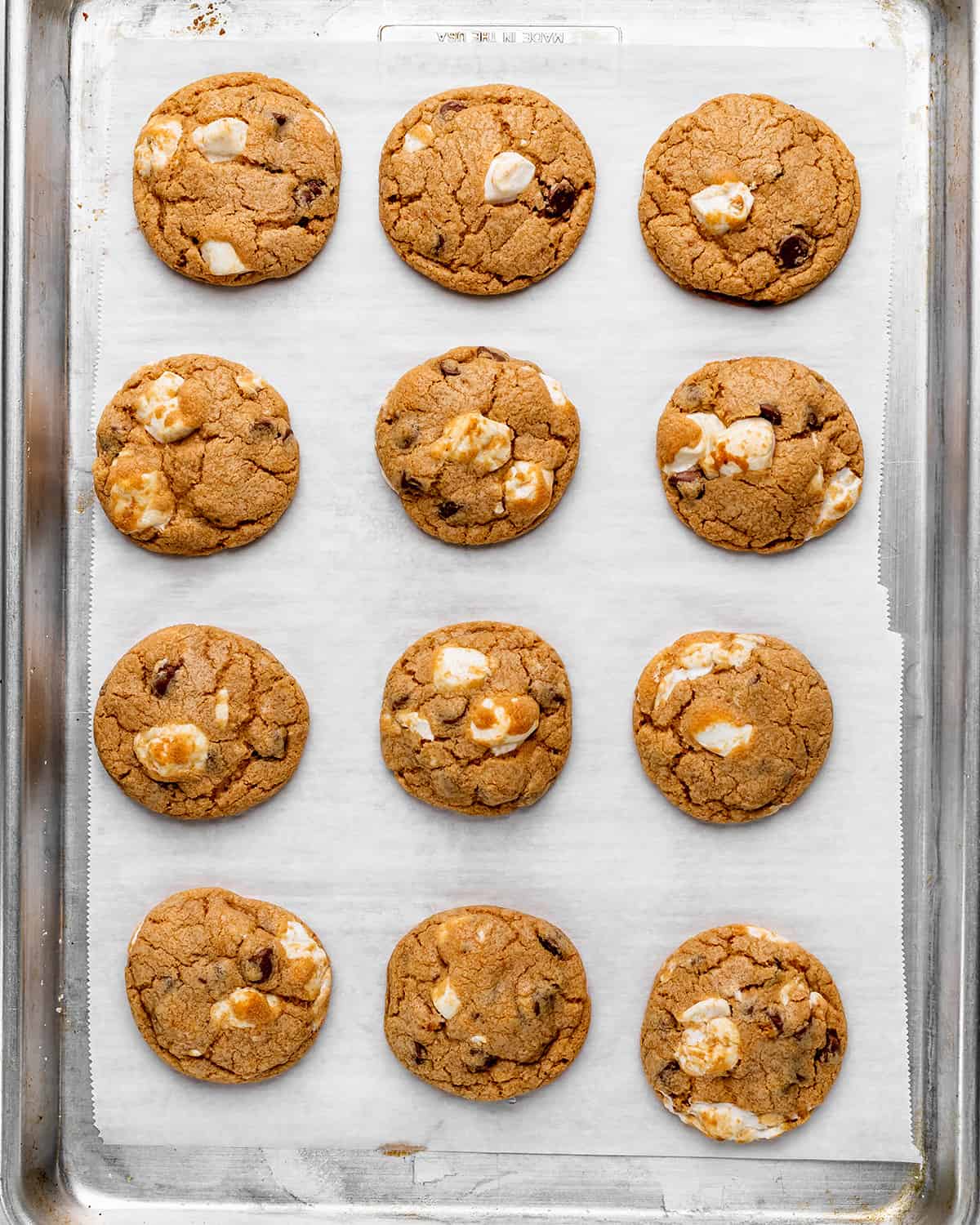 12 S'mores Cookies on a baking sheet after baking