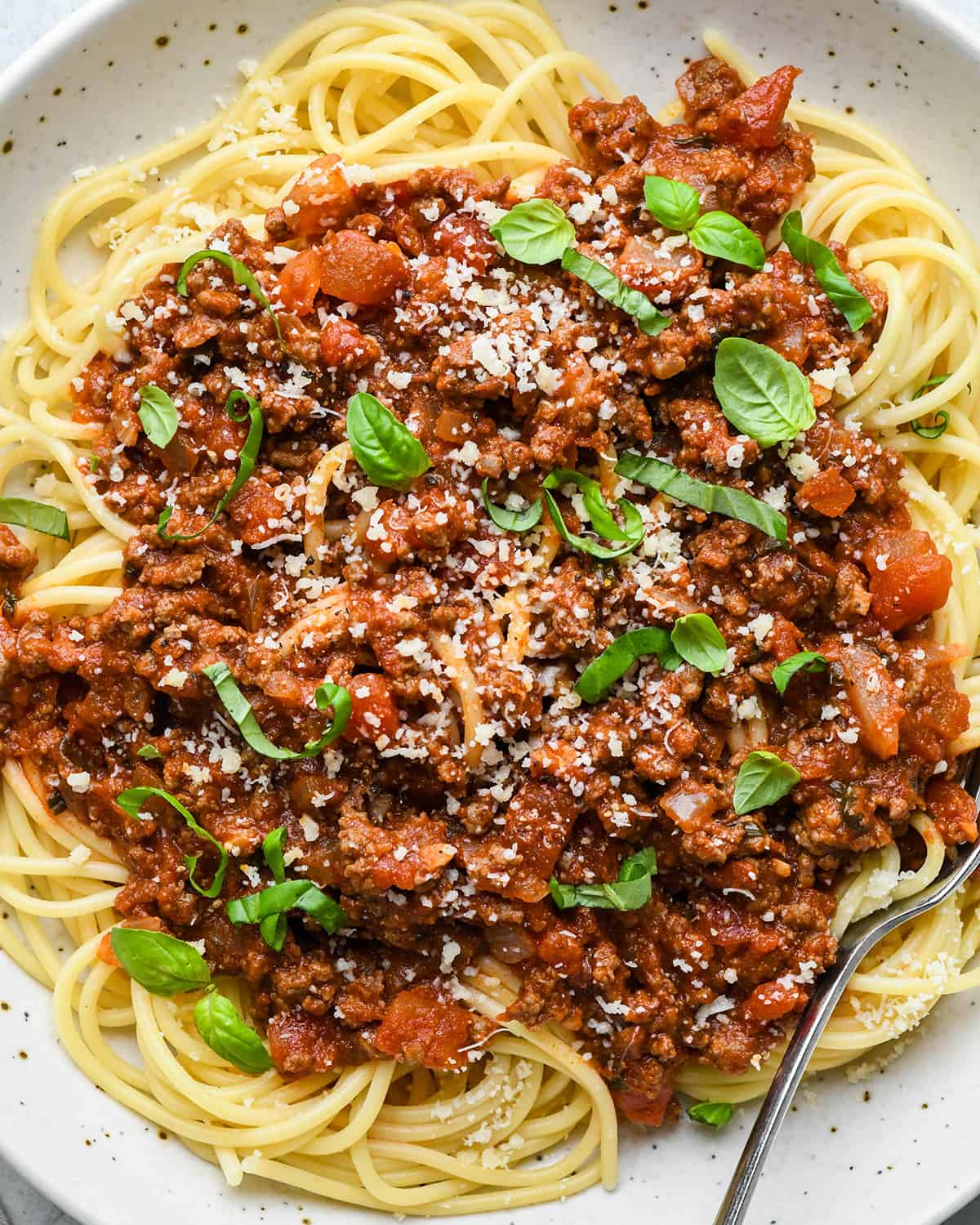 pasta with Spaghetti Meat Sauce, basil and parmesan cheese