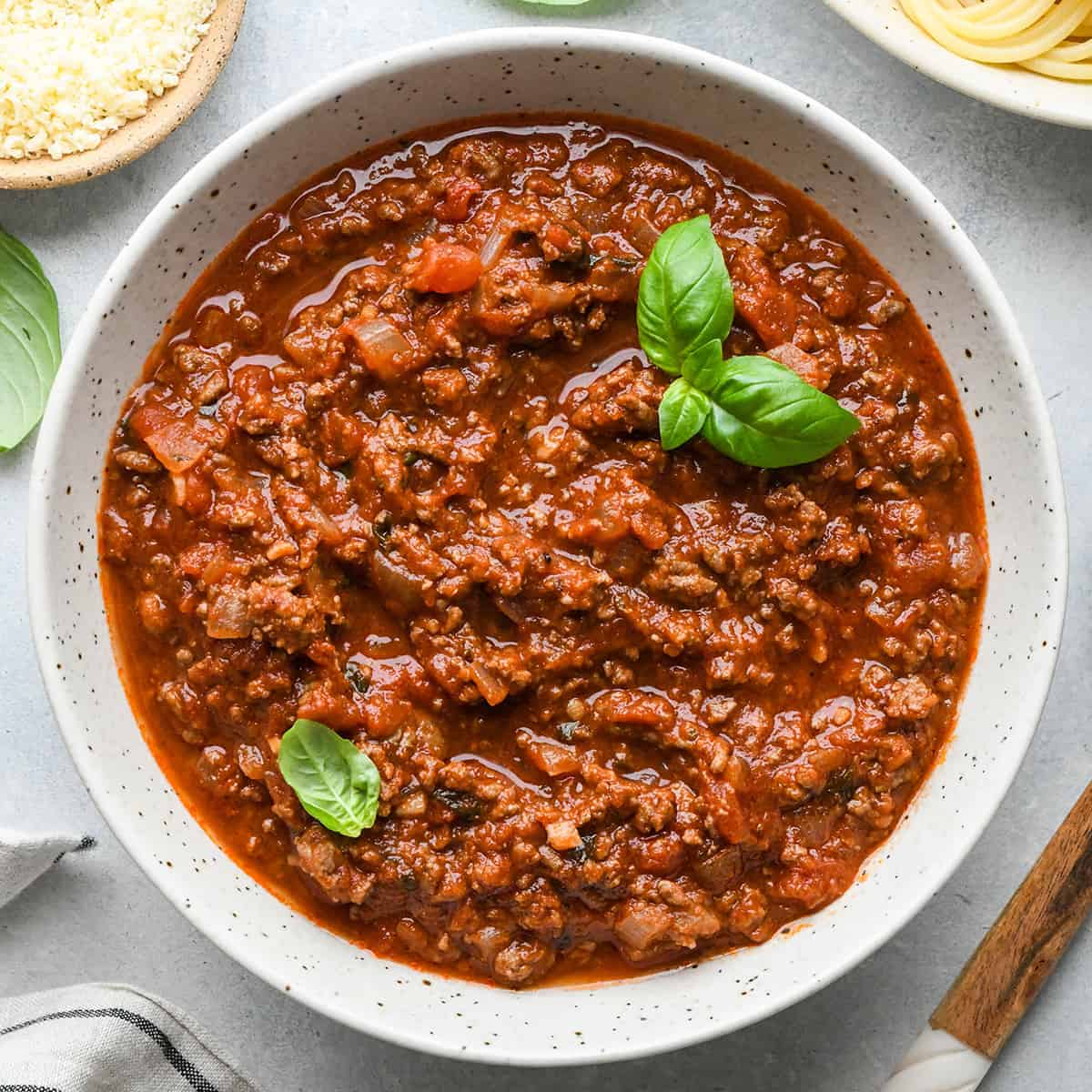 Spaghetti Meat Sauce in a bowl with fresh basil