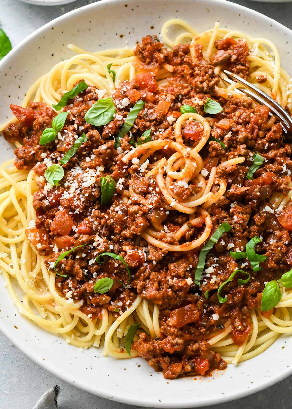 Spaghetti Meat Sauce over noodles with basil and parmesan cheese