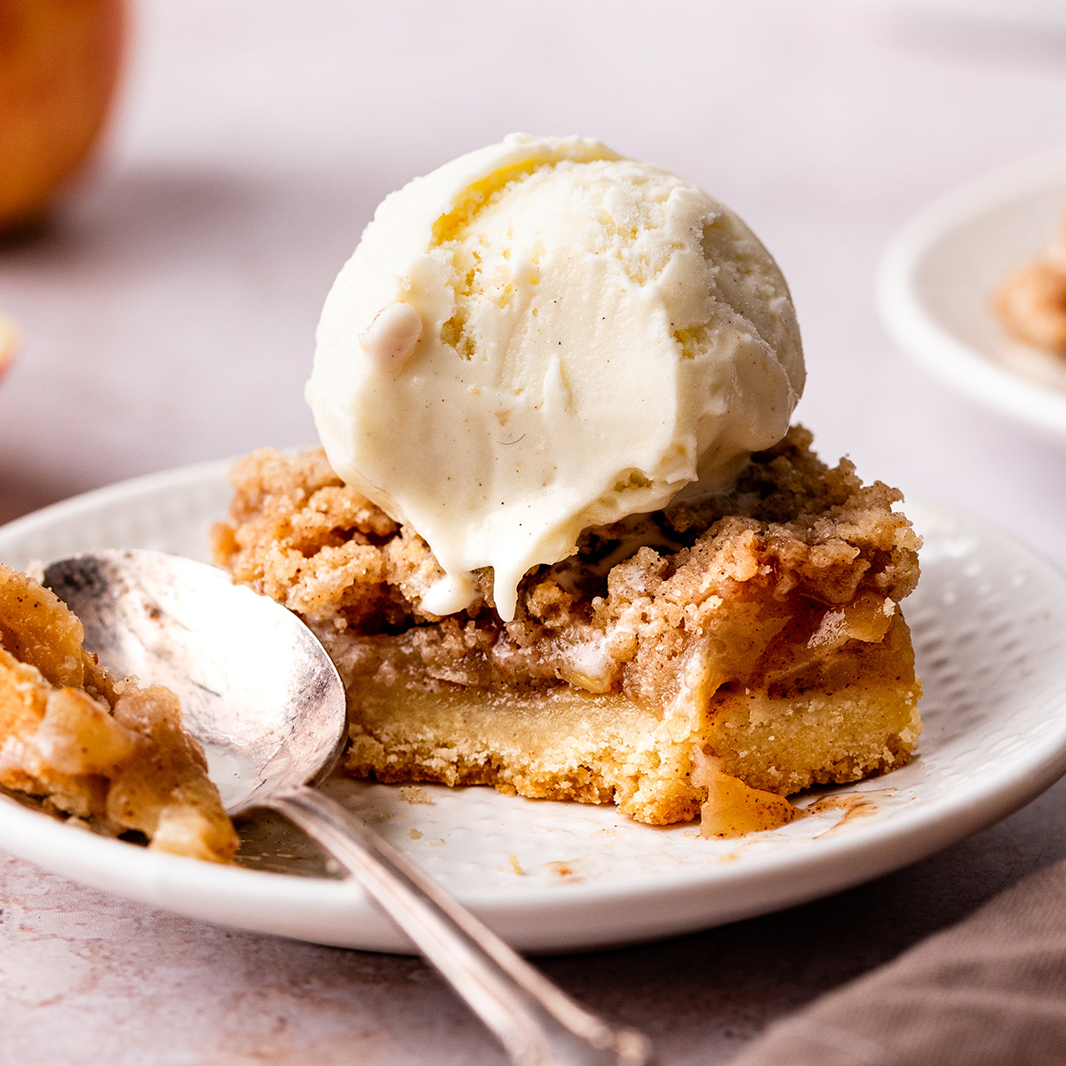 an Apple Pie Bar on a plate topped with ice cream
