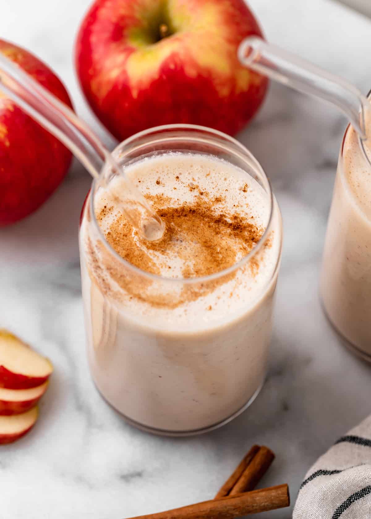 Apple Smoothie in a glass with a glass straw