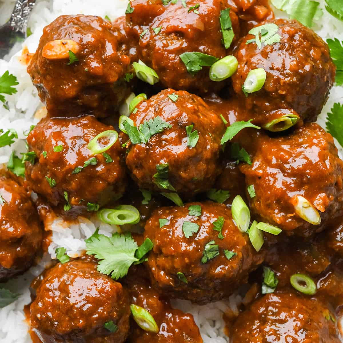 BBQ Meatballs garnished with cilantro and green onions over rice