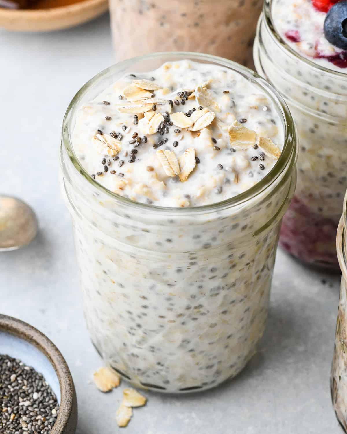 Overnight Oats in a glass jar topped with chia seeds and oats