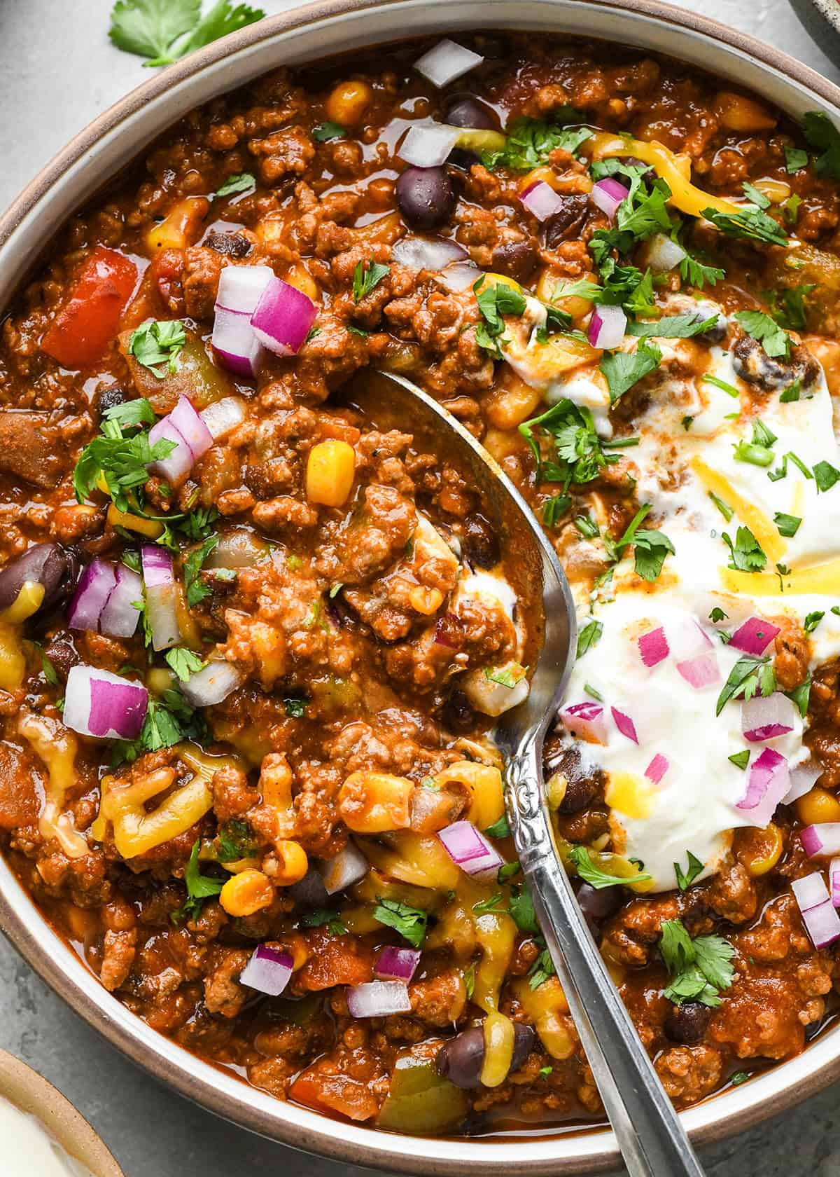 a spoon taking a bite of Crock Pot Chili in a bowl