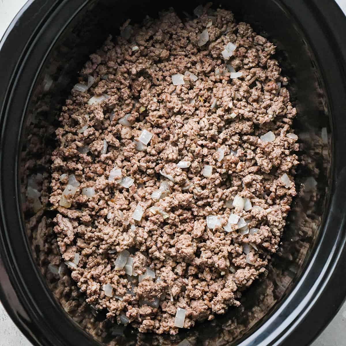 cooked ground beef mixture in a crockpot