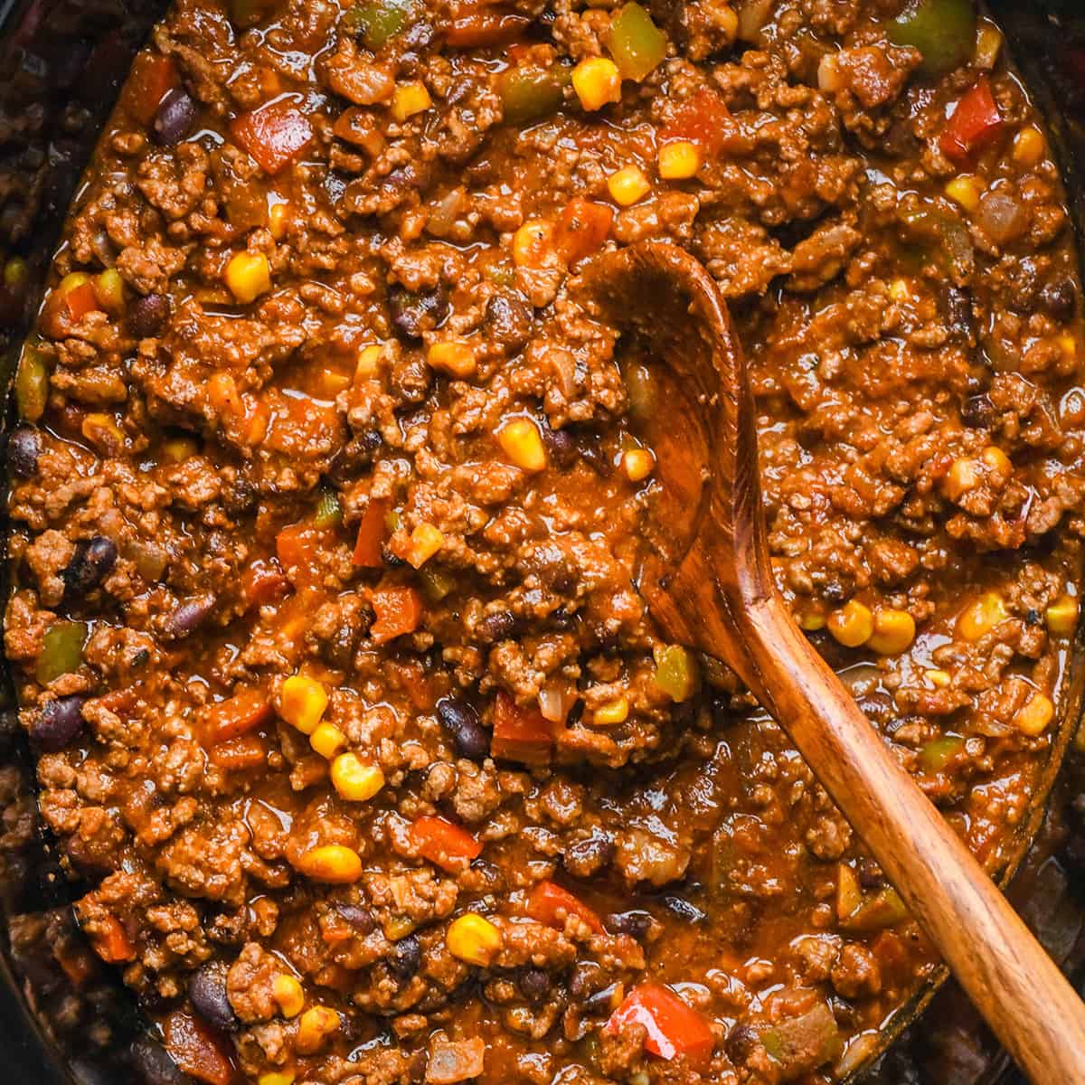 Crock Pot Chili Recipe in a crockpot with a wooden spoon