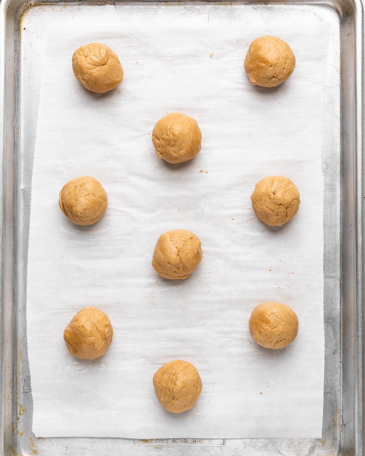 9 Maple Cookie dough balls on a baking sheet before baking