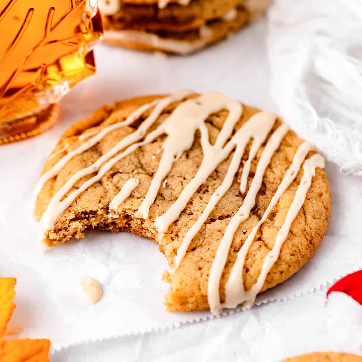 a maple cookie with maple glaze and a bite taken out of it