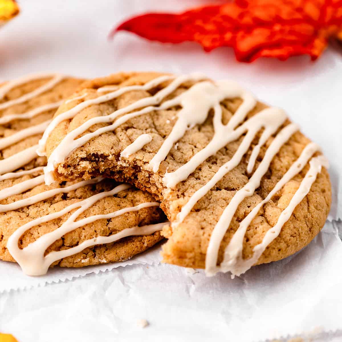 two Maple Cookies with maple glaze, one with a bite taken out of it