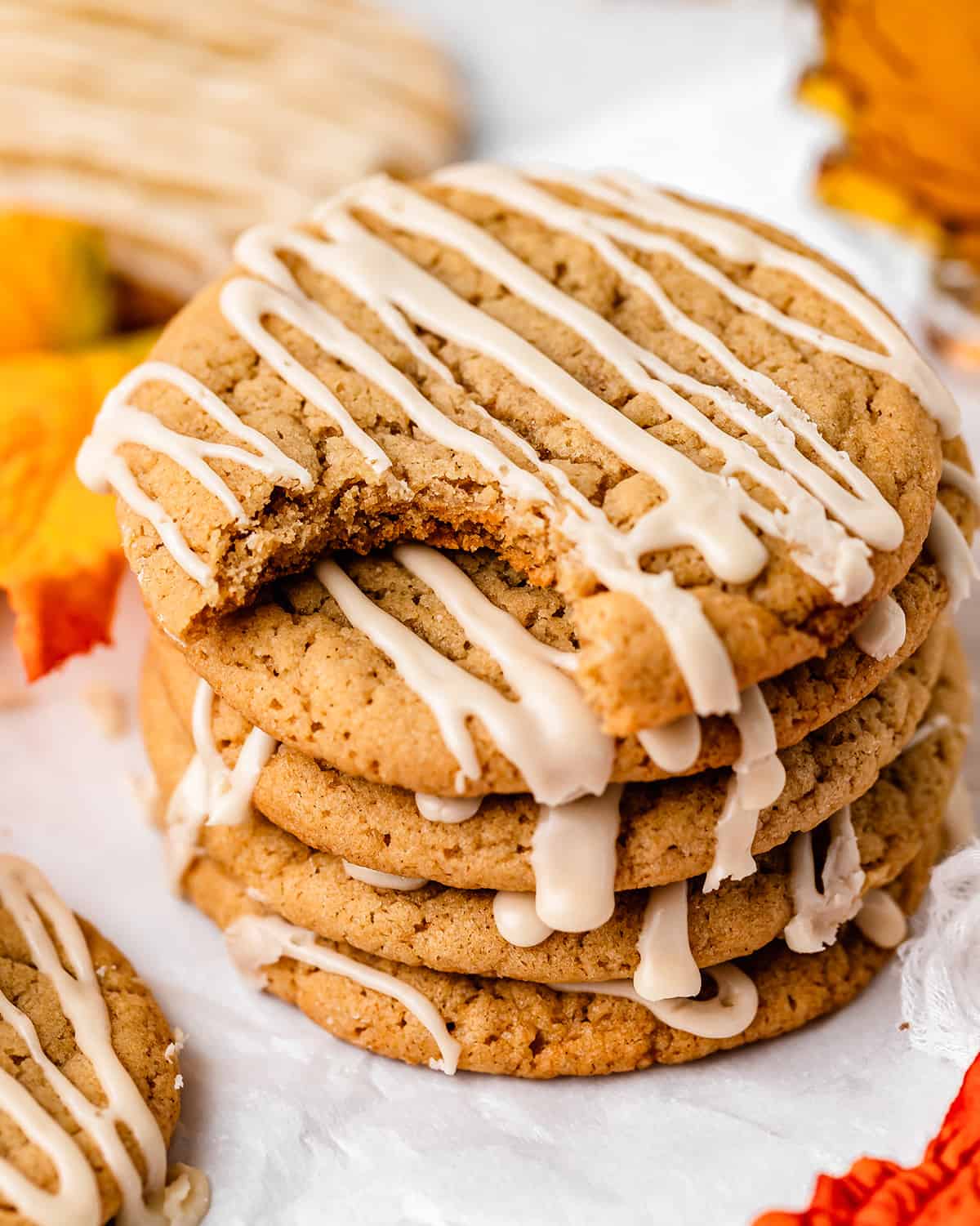 a stack of 5 Maple Cookies with maple glaze, the top one has a bite taken out of it