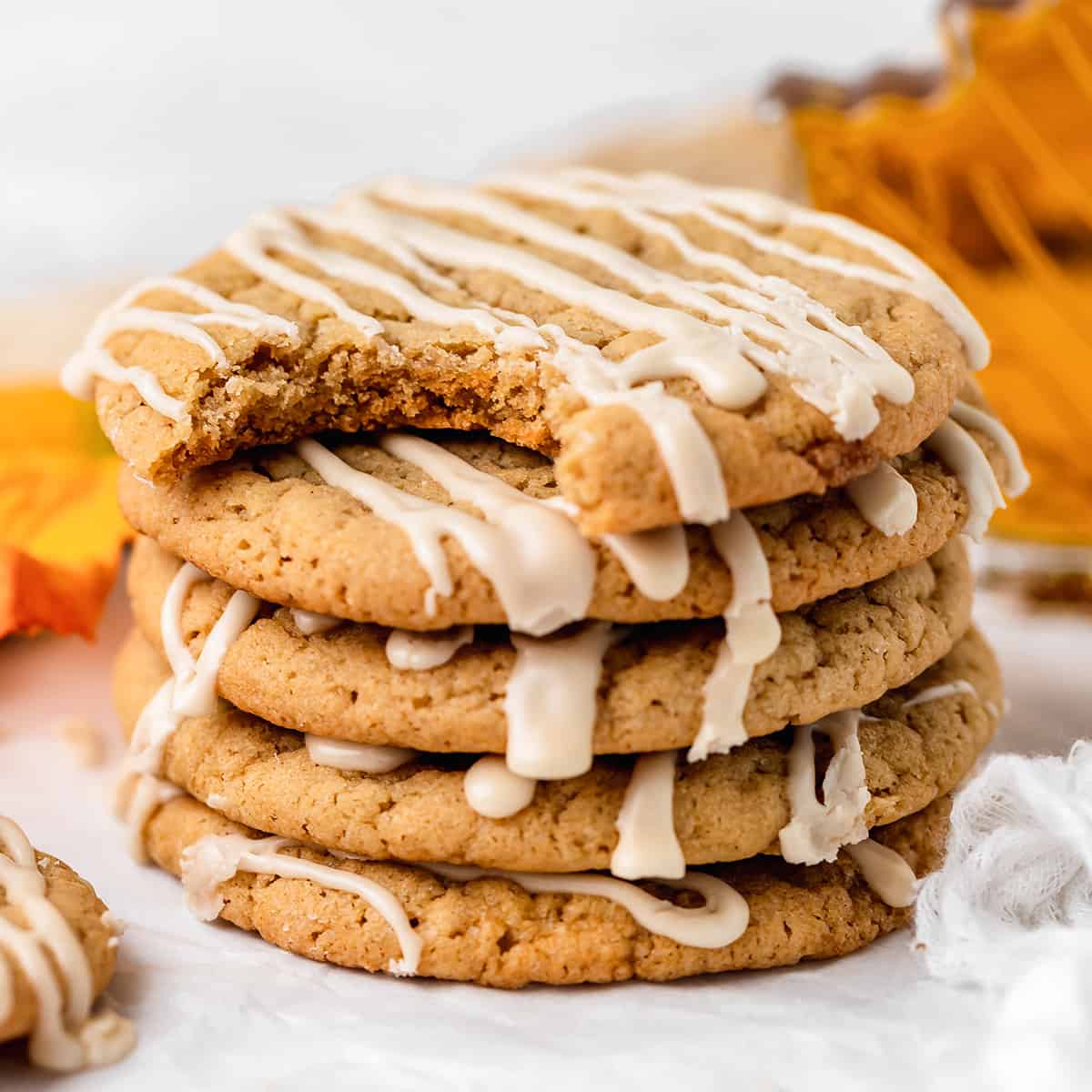 a stack of 5 Maple Cookies with maple glaze, the top one has a bite taken out of it