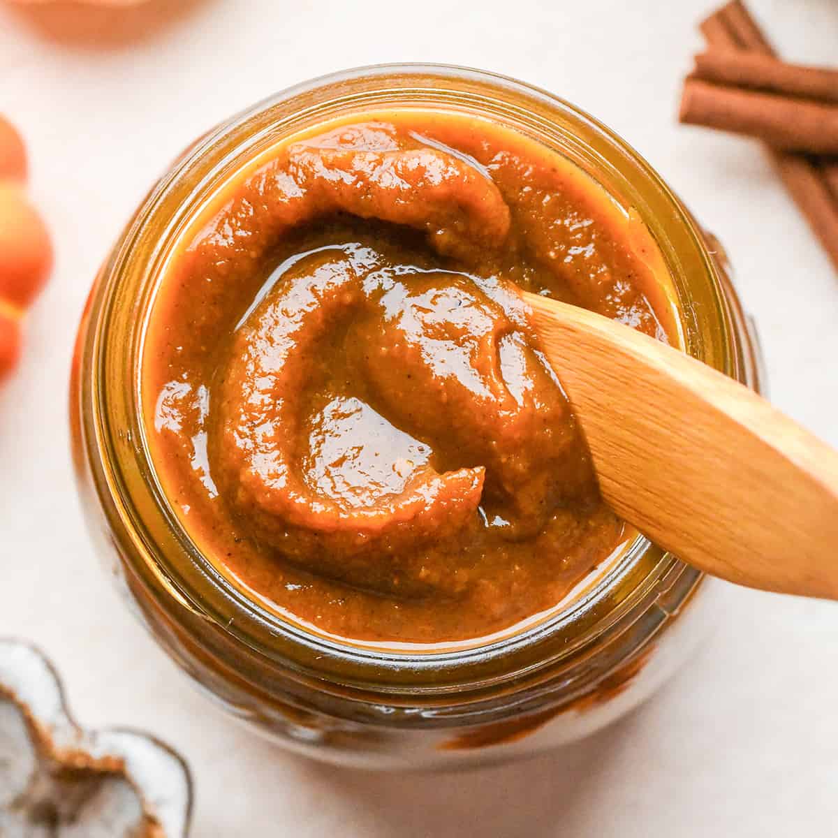 Pumpkin Butter in a glass jar with a knife