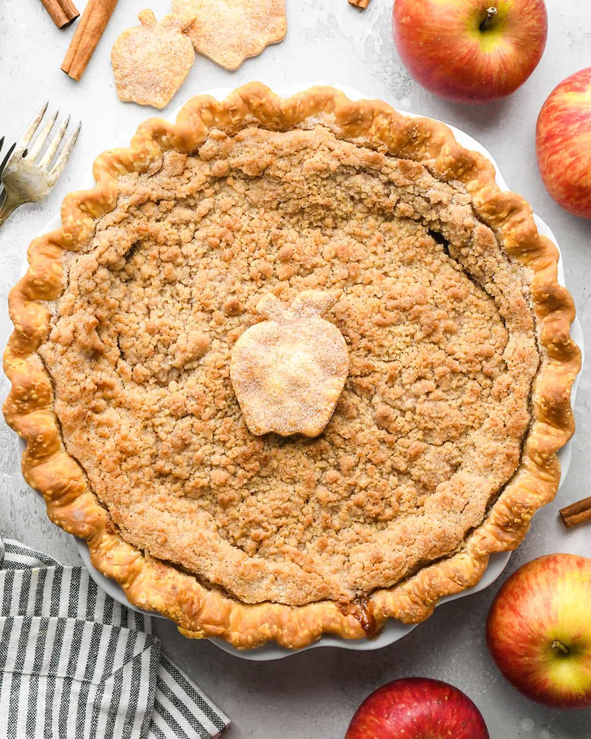 Apple Crumb Pie in a pie dish with a pie crust apple on top