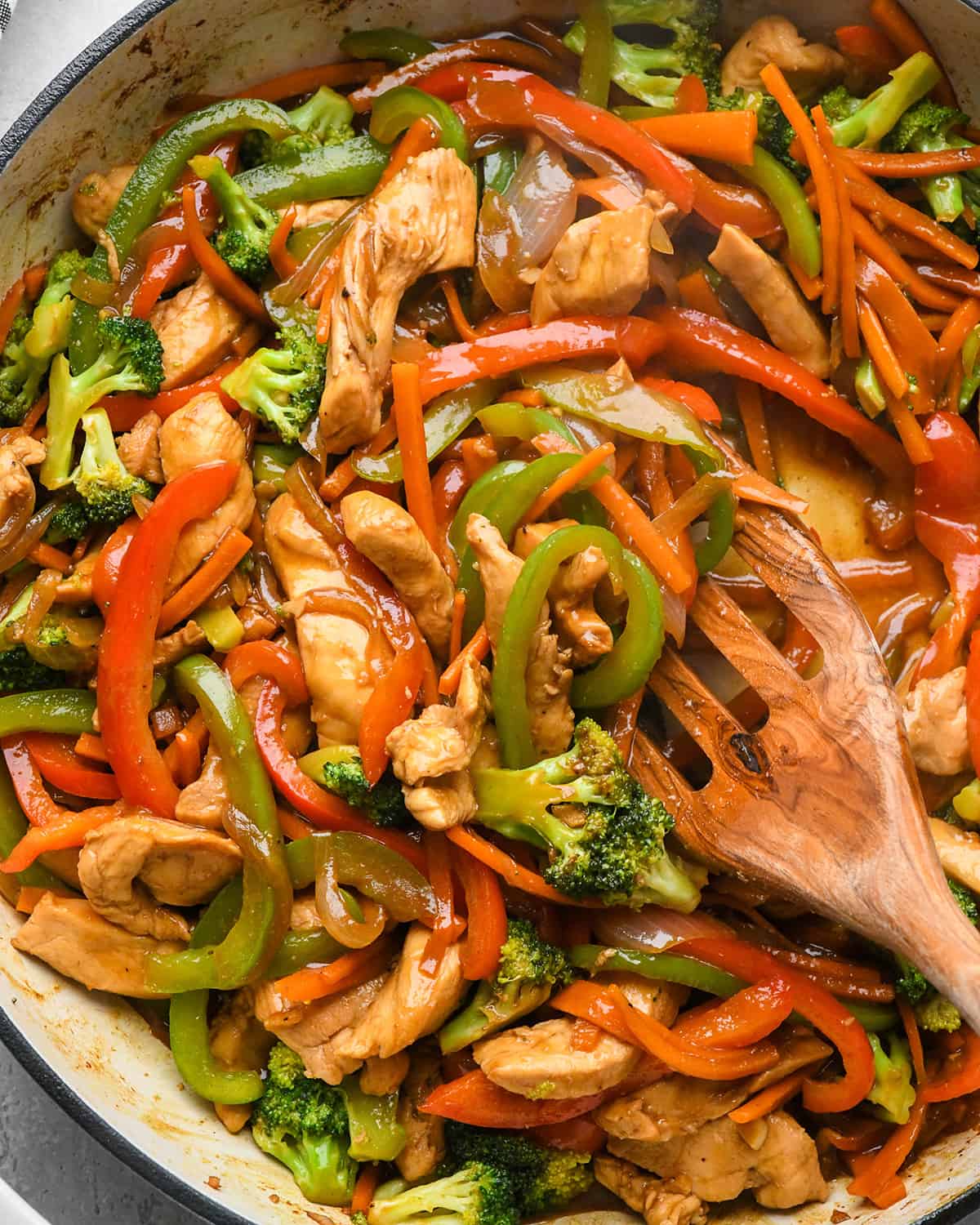 Chicken Stir Fry in a pan with a wooden spatula