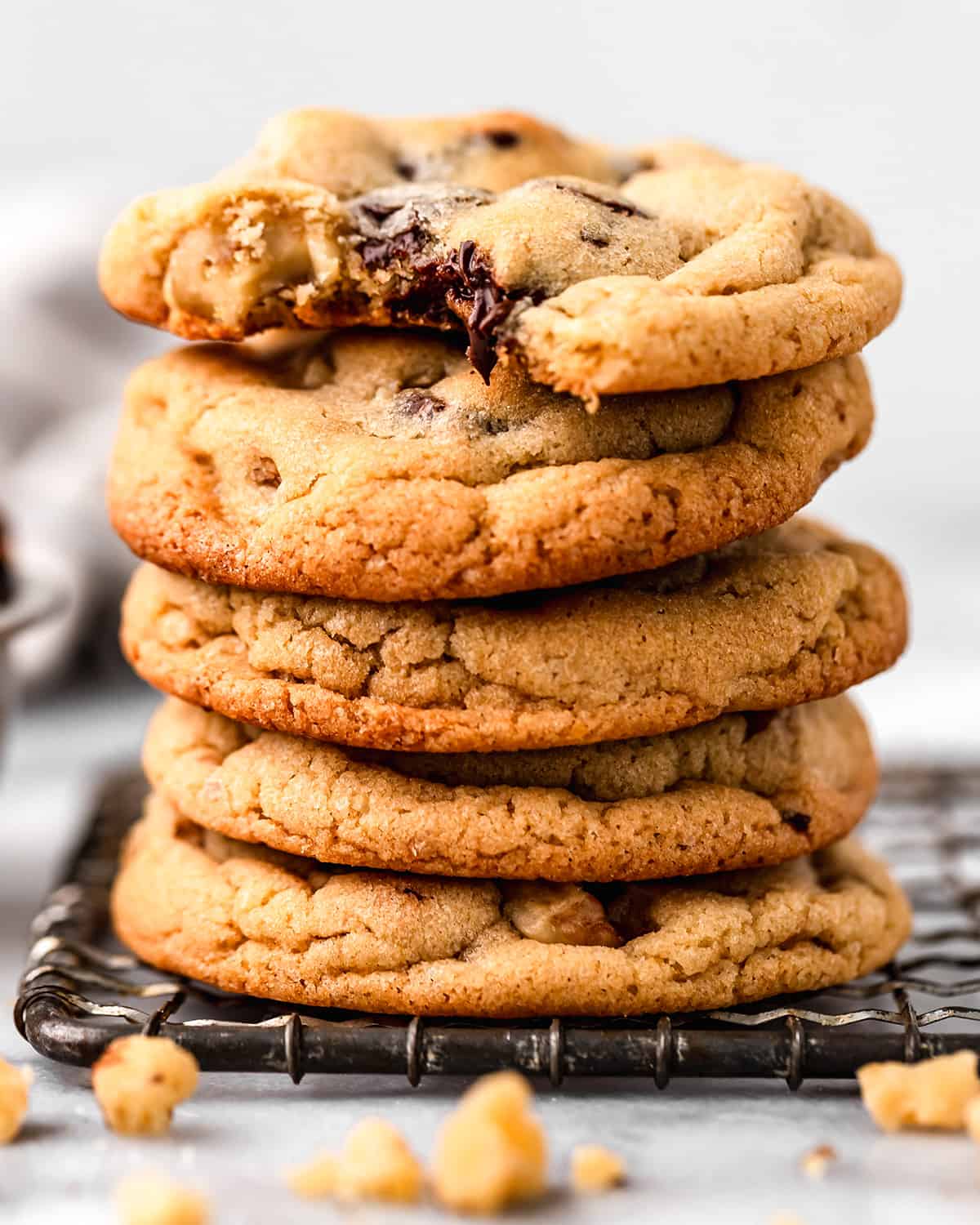 a stack of 5 Chocolate Chip Walnut Cookies, the top one has a bite taken out of it