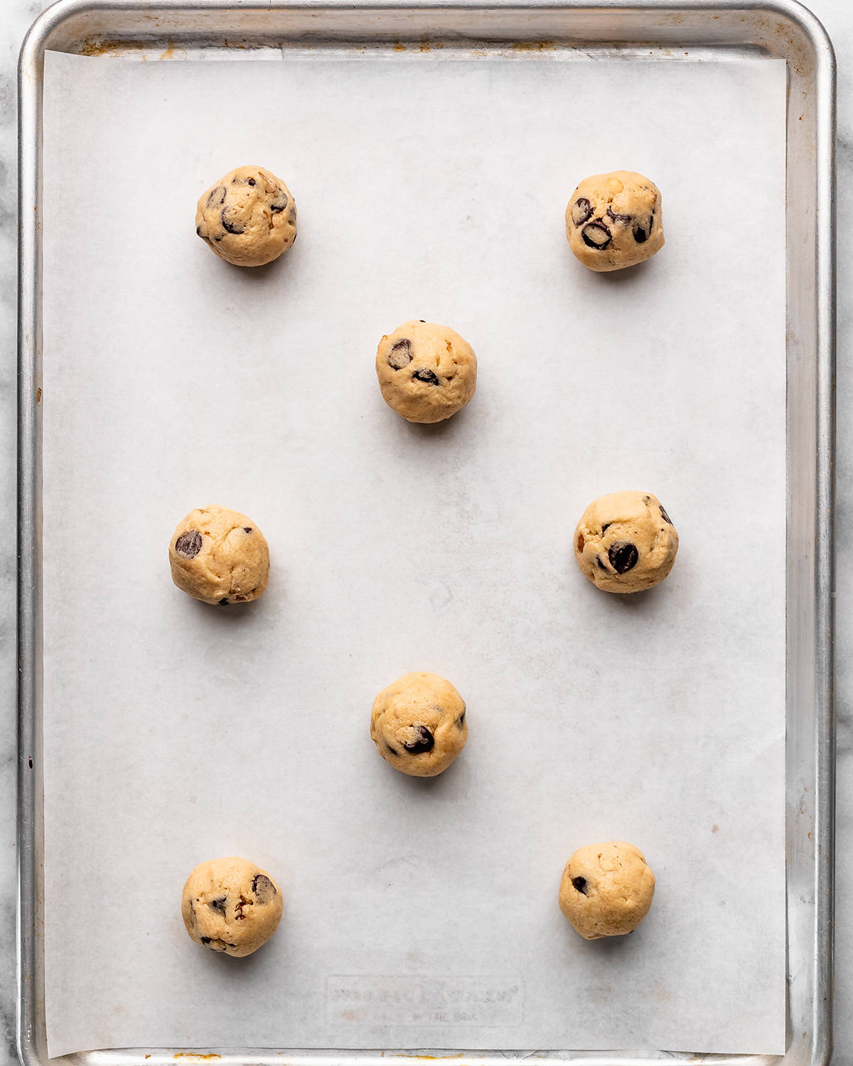 8 Chocolate Chip Walnut Cookies on a baking sheet before baking