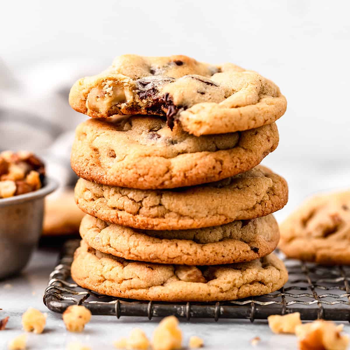 a stack of 5 Chocolate Chip Walnut Cookies, the top one with a bite taken out of it