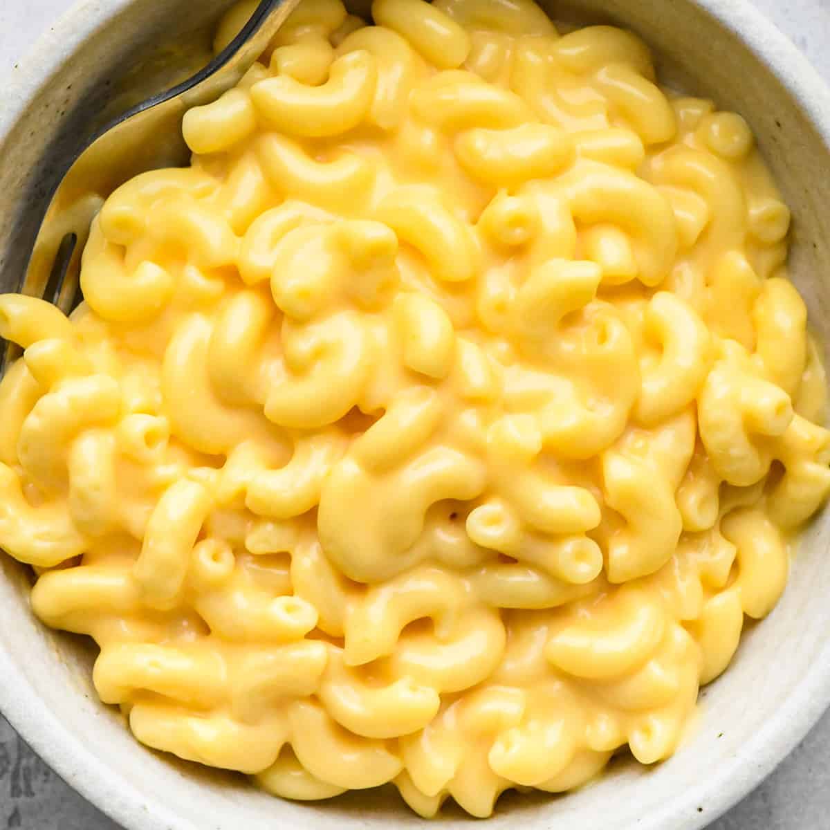 homemade macaroni and cheese in a bowl with a fork 