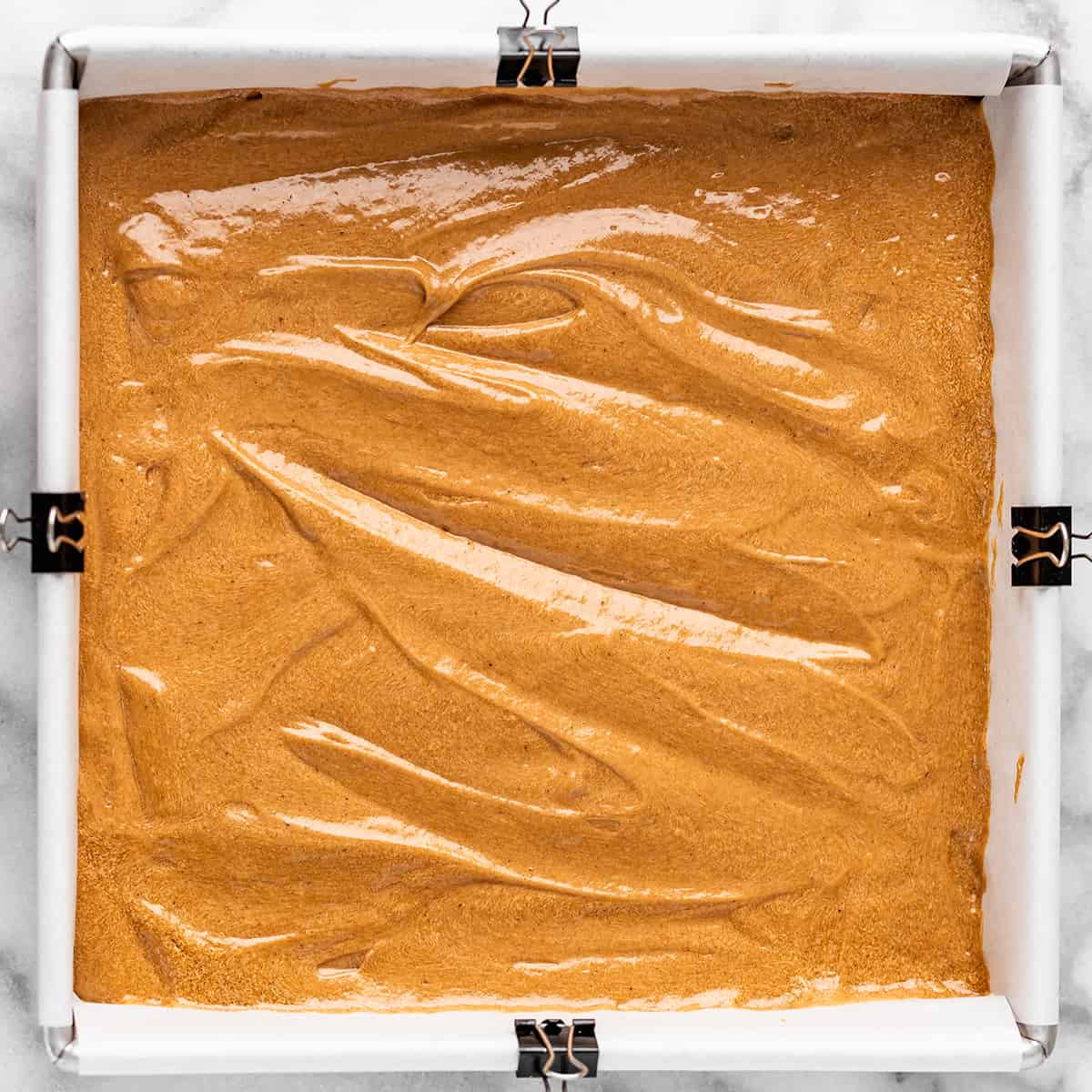 gingerbread batter in a baking pan before baking