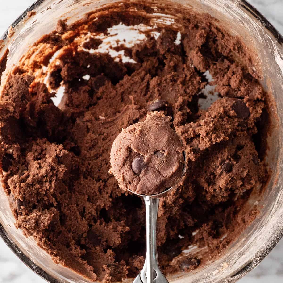 Nutella cookie dough being scooped with a cookie scoop