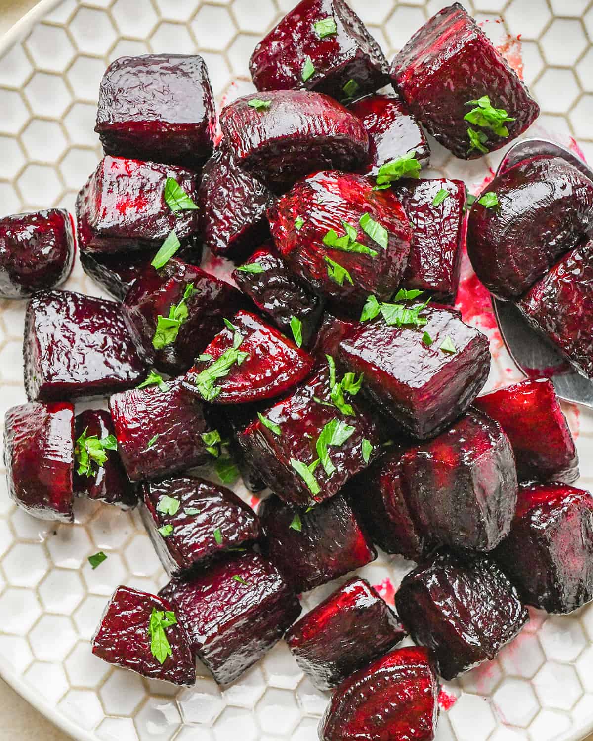 Oven Roasted Beets on a plate garnished with greens