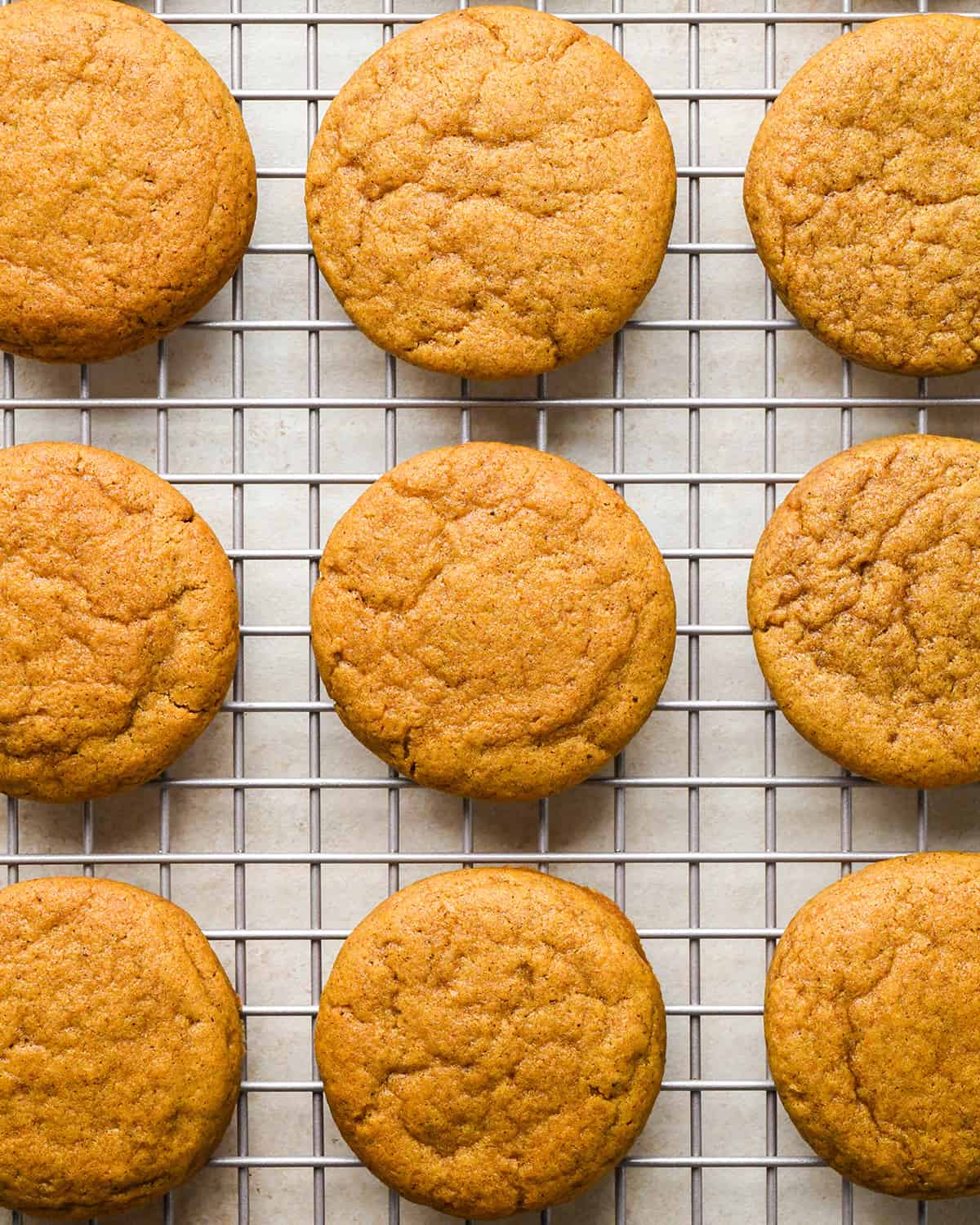 9 pumpkin cookies on a wire coolikng rack