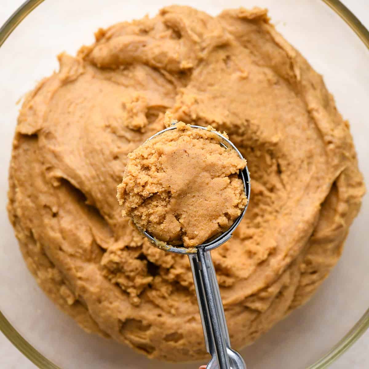 pumpkin cookie dough measured into a cookie scoop