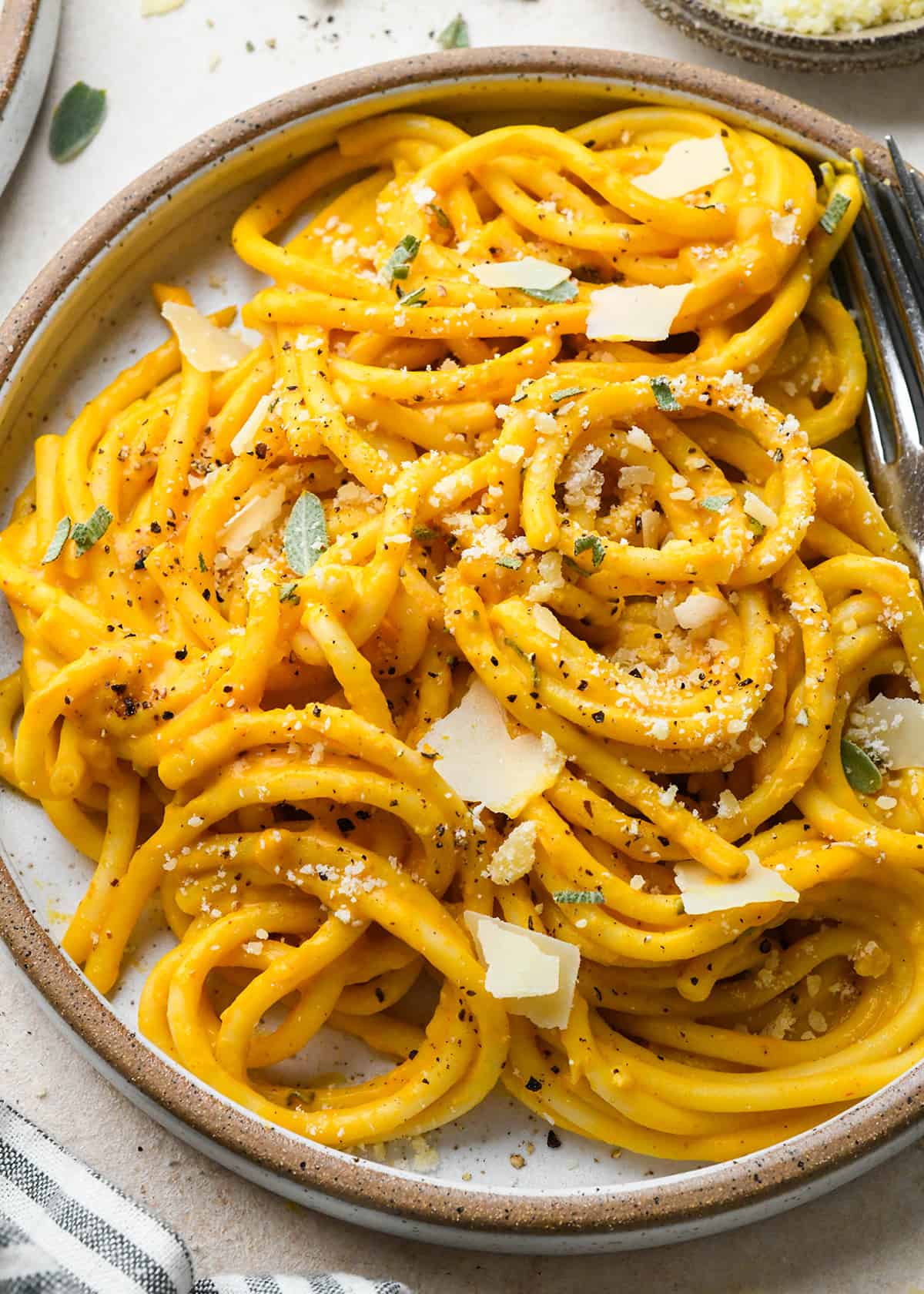 Pumpkin Pasta on a plate garnished with parmesan and sage