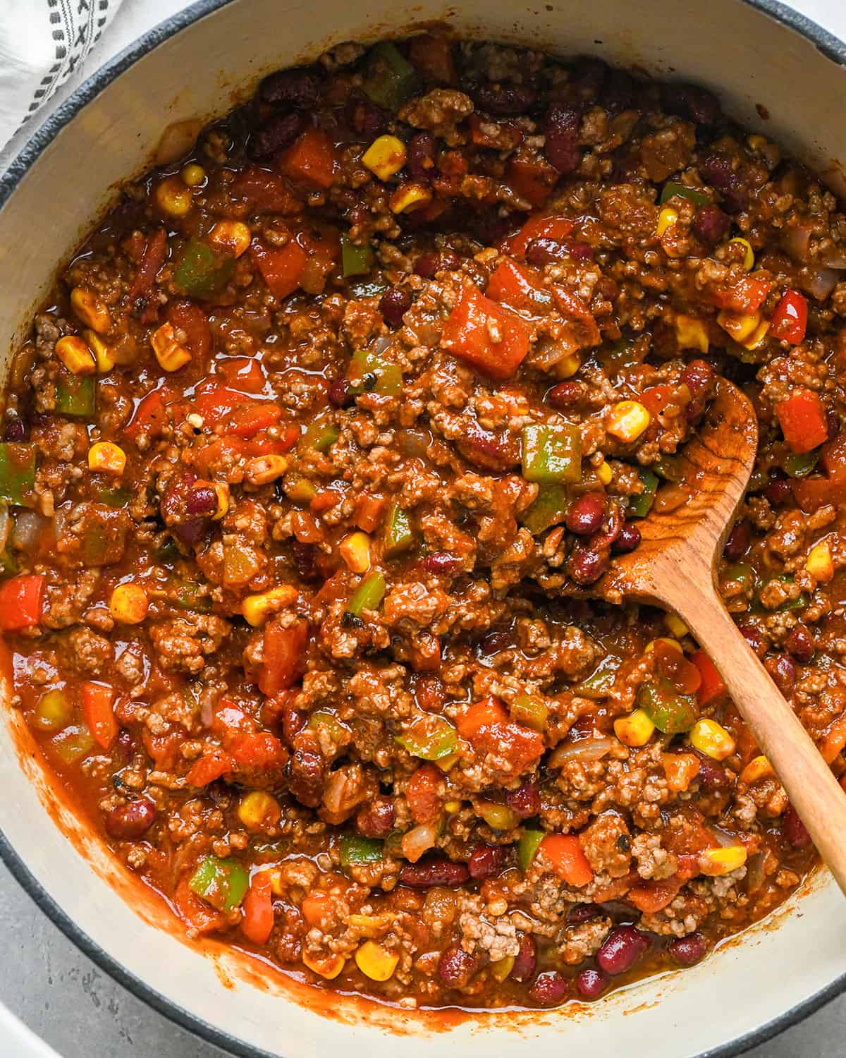 best easy chili recipe in a pot with a wooden spoon