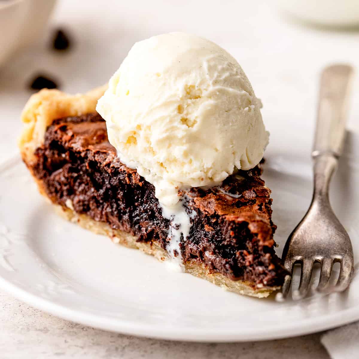 a slice of Brownie Pie with ice cream on top