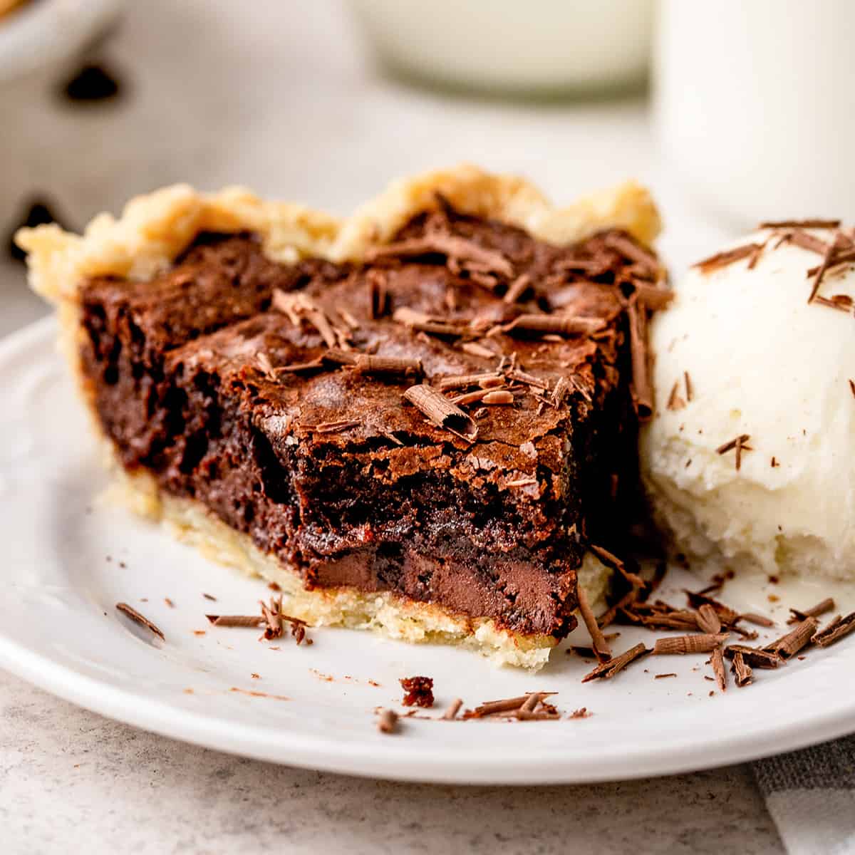 a slice of Brownie Pie on a plate with ice cream and a bite taken out of it