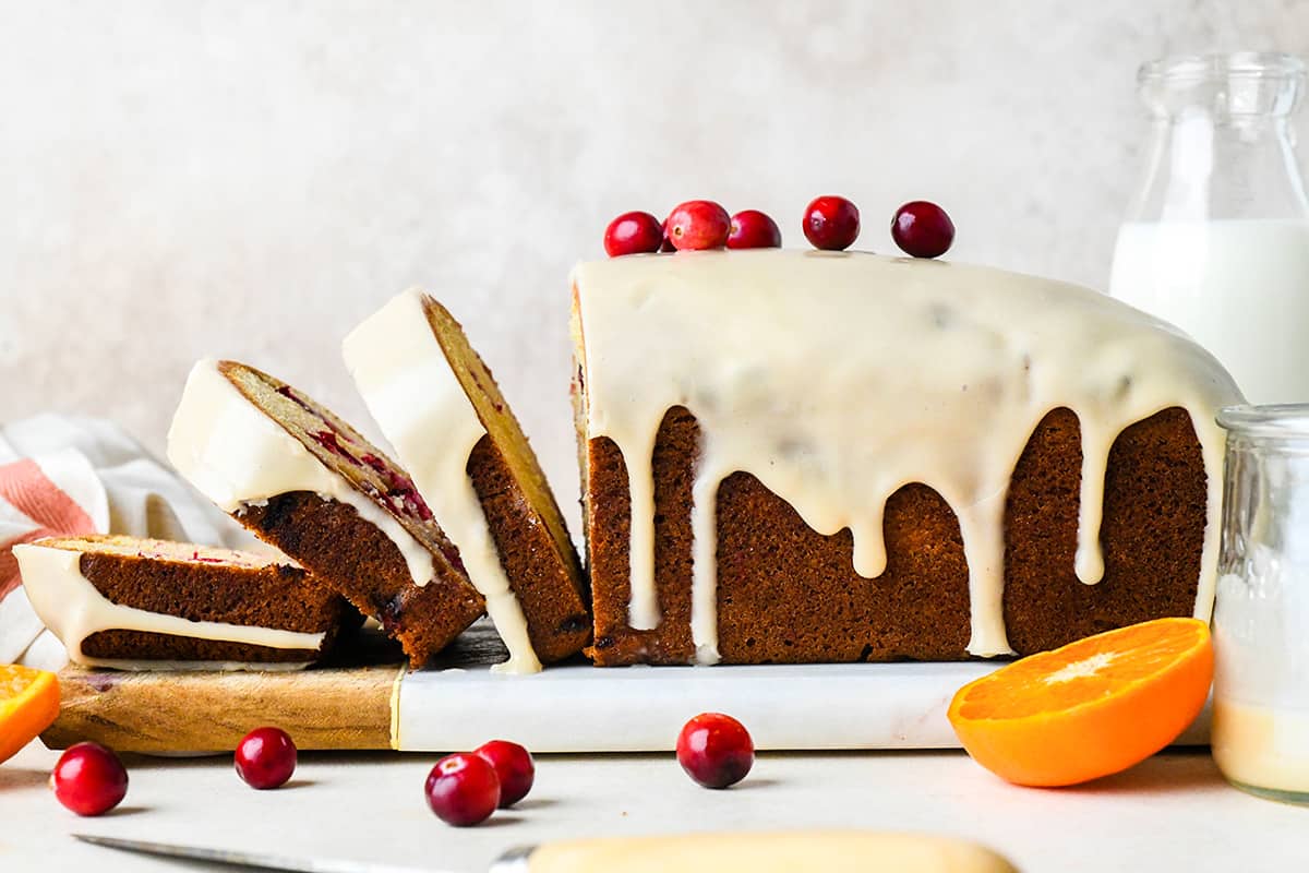 a loaf of Cranberry Orange Bread with 3 slices cut out of it