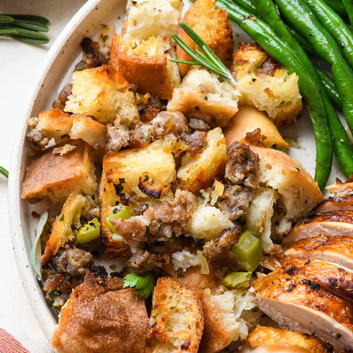 Homemade Stuffing on a plate with other thanksgiving foods